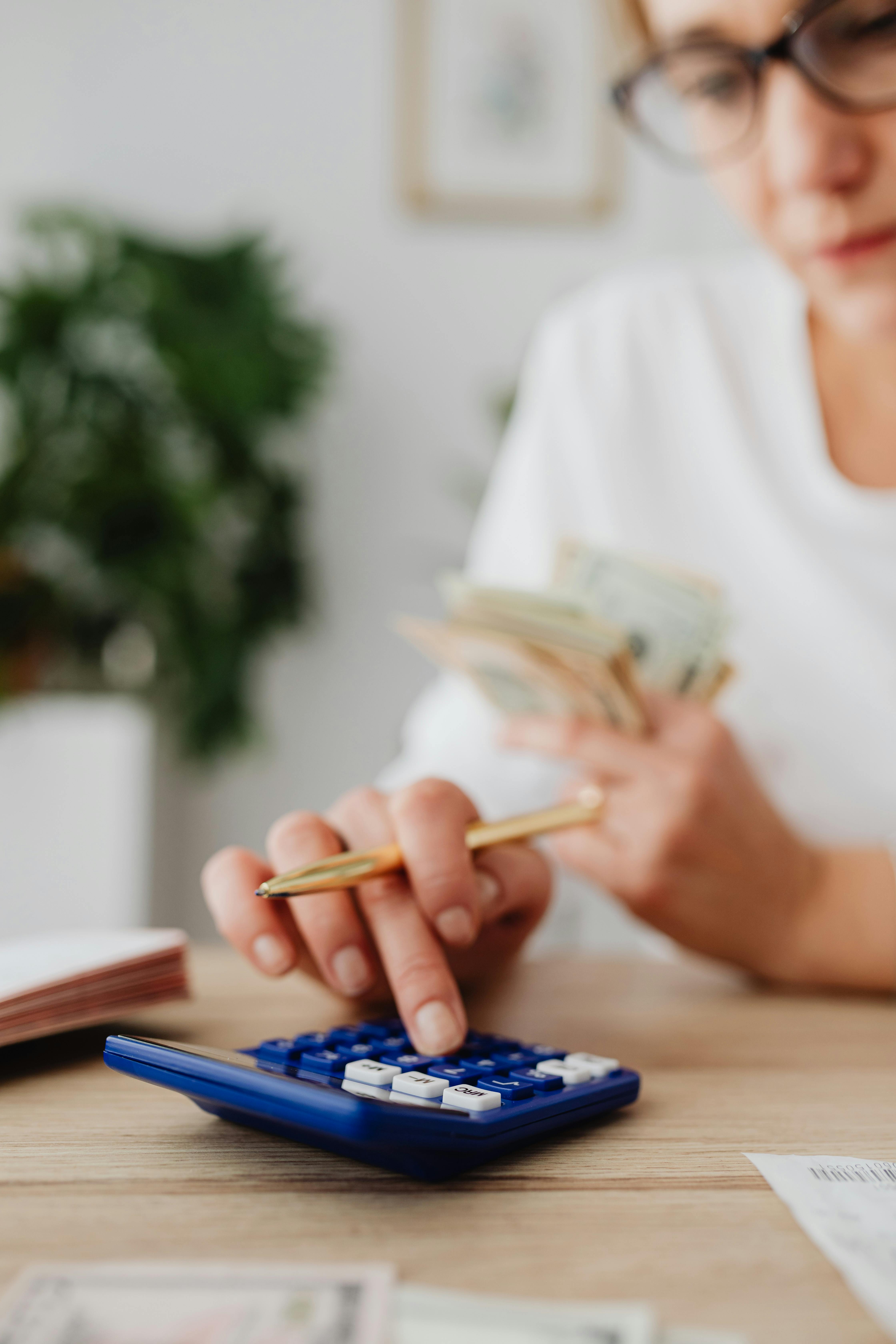 School budget planning with calculator and cash flow management during April budget